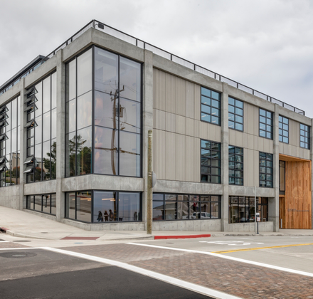 A view of the modern Bechtel Center from across the street corner on a foggy day