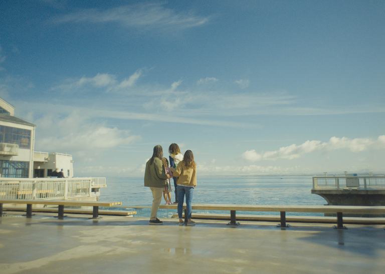 Family looking off into Monterey Bay of the back deck of the Aquarium