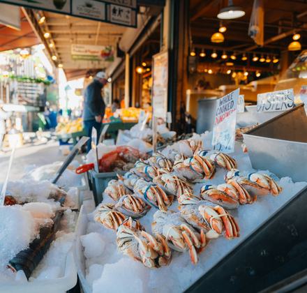 Outdoor seafood counter displaying crab and oysters